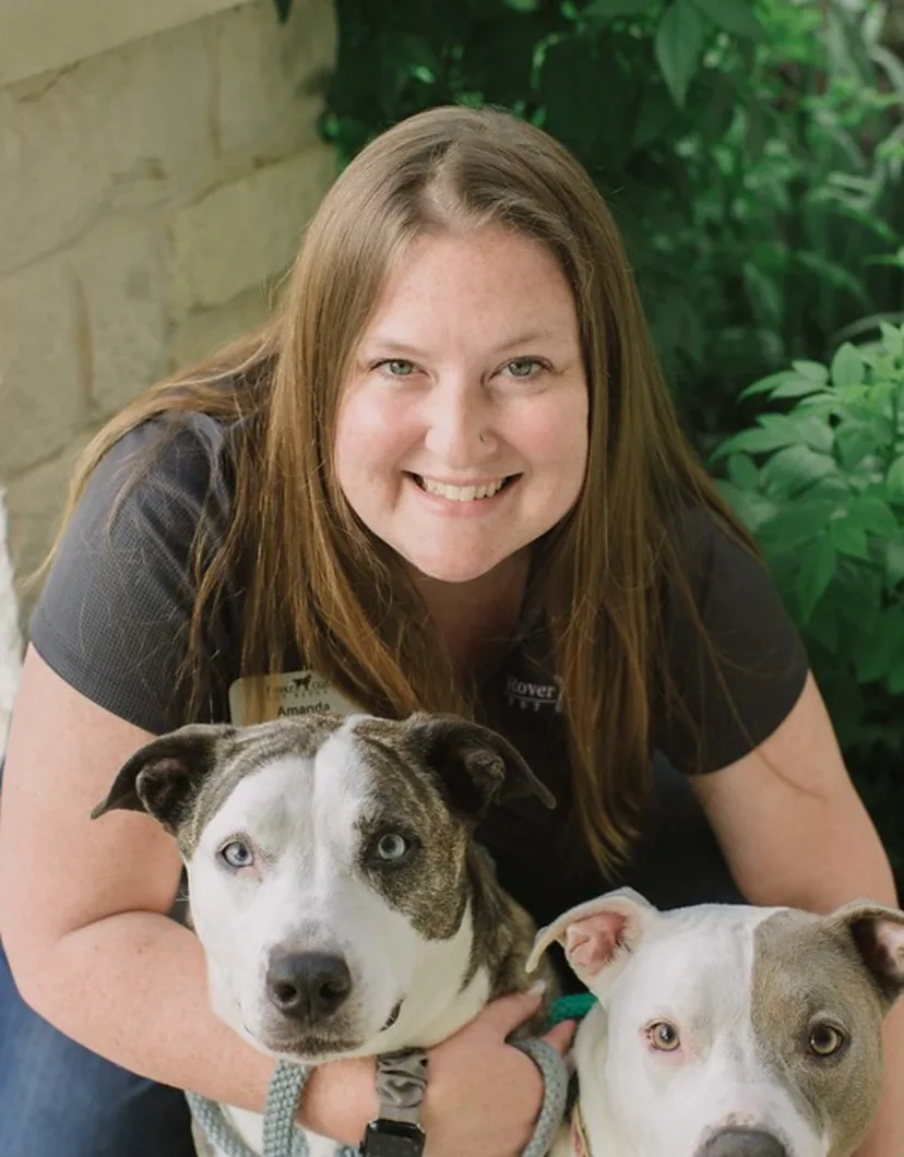 Amanda Alvizo posing with two dogs